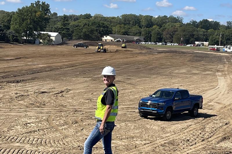 Picture of construction area with a woman smiling