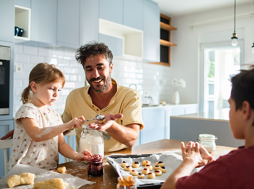 A family bakes together in their kitchen