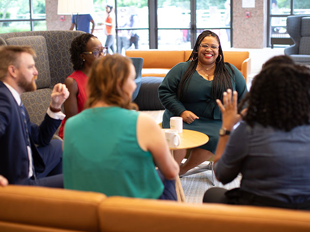 Freddie Mac employees conversing in a common area