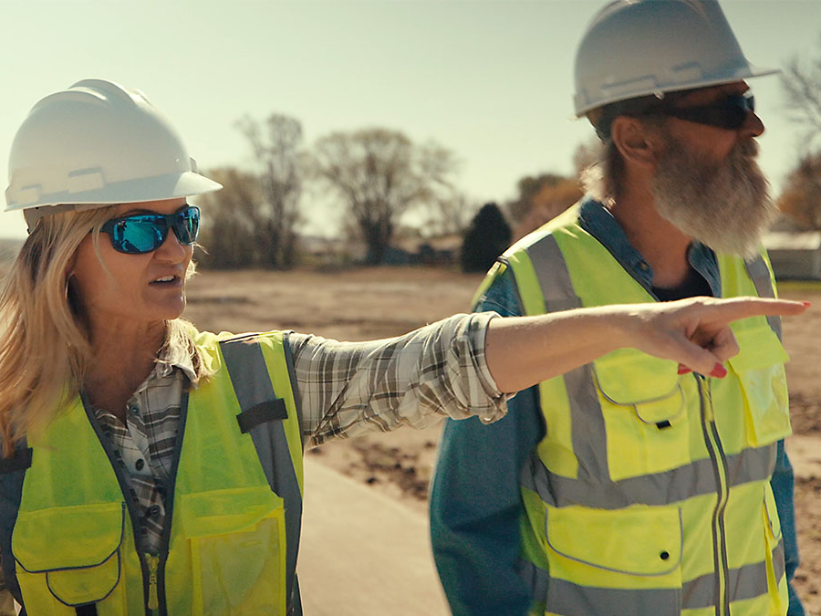 Man and woman at a construction site.