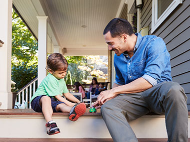 Adult male and a male child having fun playing a game.