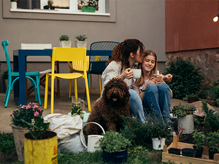 Parent and child gardening with dog