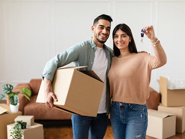 Couple holding keys to their new home