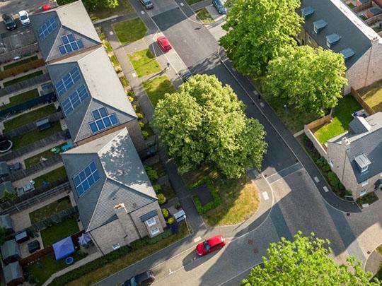 Aerial view of a neighborhood with solar panels on the roofs